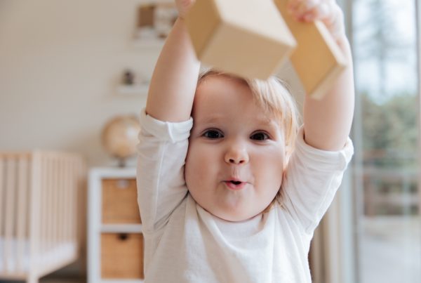 How IMS leveraged OrgHive and content marketing in China to propel an organic baby food brand as market leader | baby in white onesie holding wooden blocks 3933250